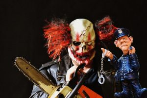 The image of an evil clown and a police officer explains the problems facing law enforcement seeking executive protection training.
